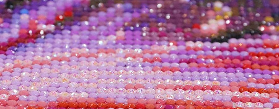 Colorful AB diamonds from diamondpainting.de arranged in a creative pattern.