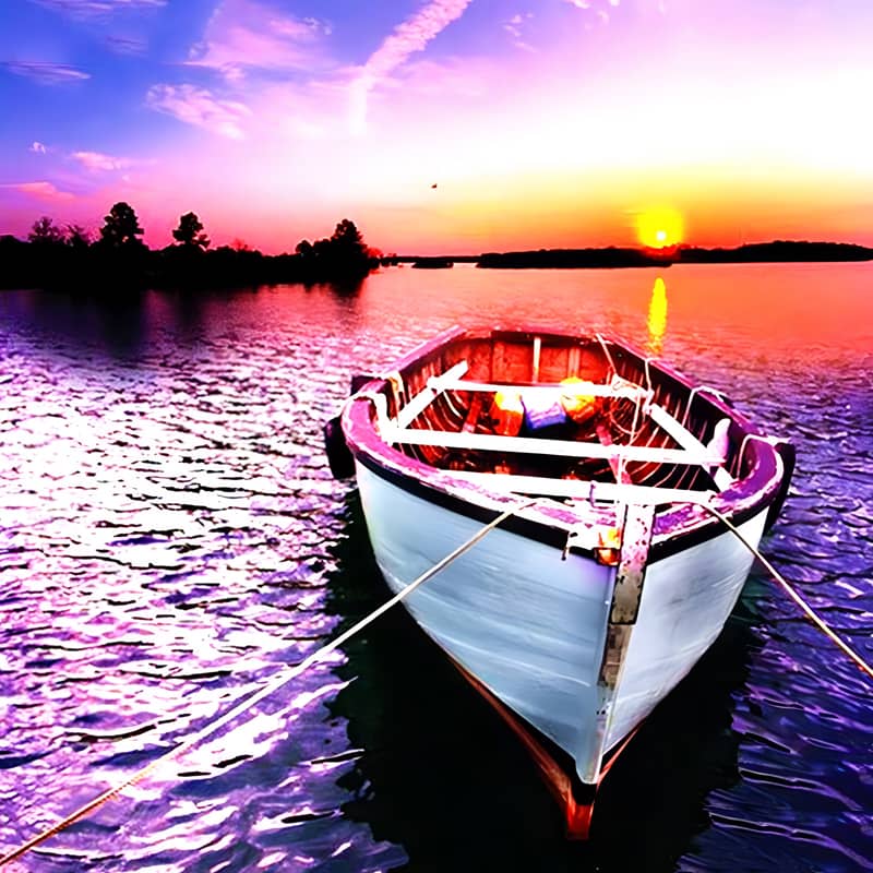Wooden boat anchored on serene lake at sunset with vibrant sky and calm waters