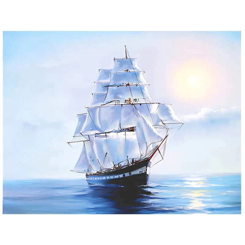 Sailing ship with white sails on a calm sea at sunrise