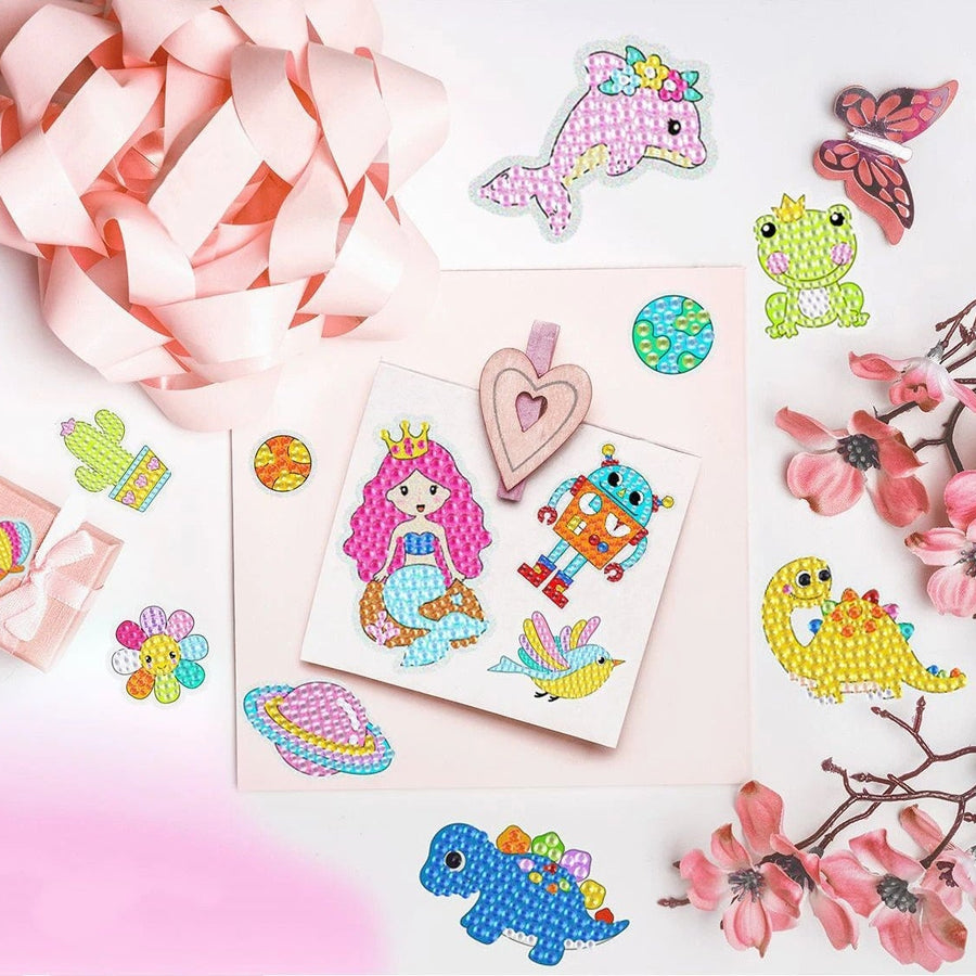 Colorful stickers featuring a mermaid, robot, unicorn, and various animals with a pink ribbon and flower decoration.