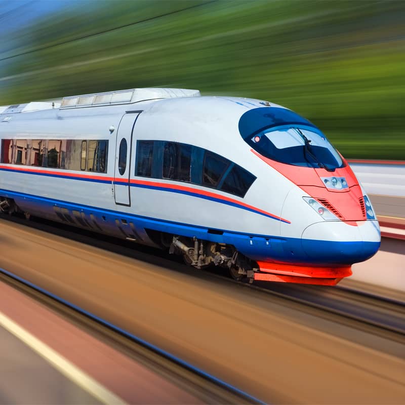 High-speed train moving swiftly on railway tracks.