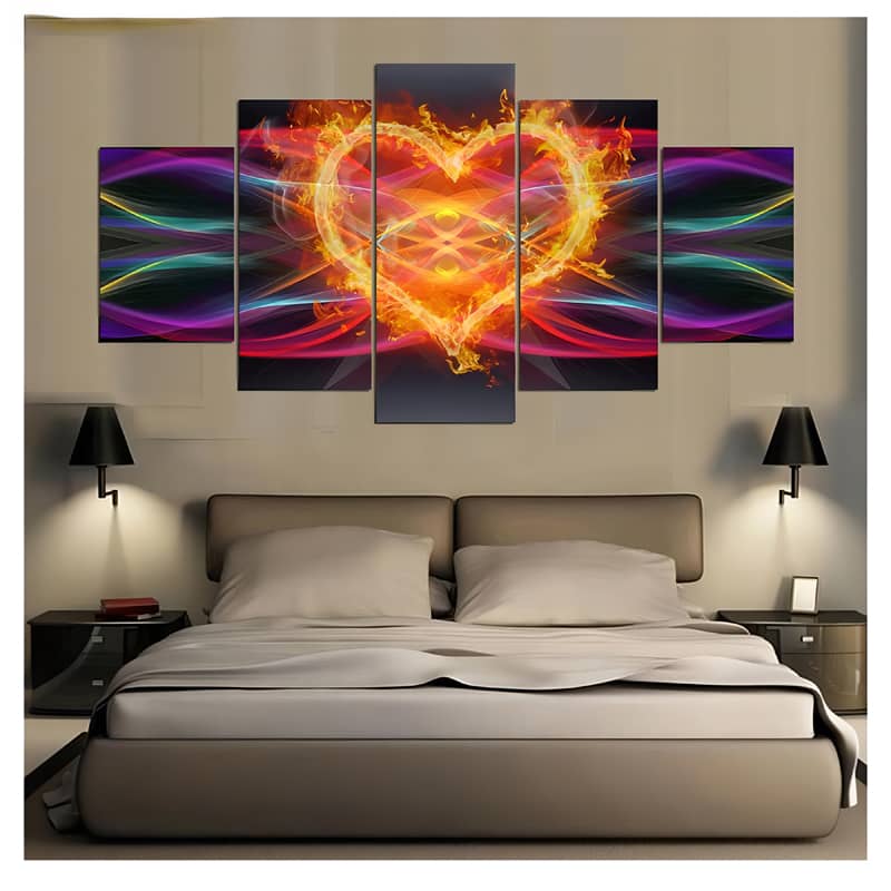 Diamond painting wall art featuring a vibrant fire heart with colorful waves on five separate panels, displayed above a modern bed.