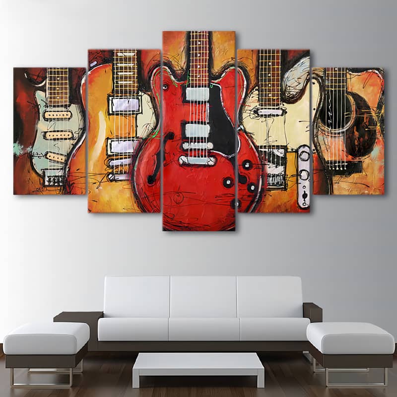 Diamond painting of five guitars in vibrant colors displayed above a modern white sofa in a living room