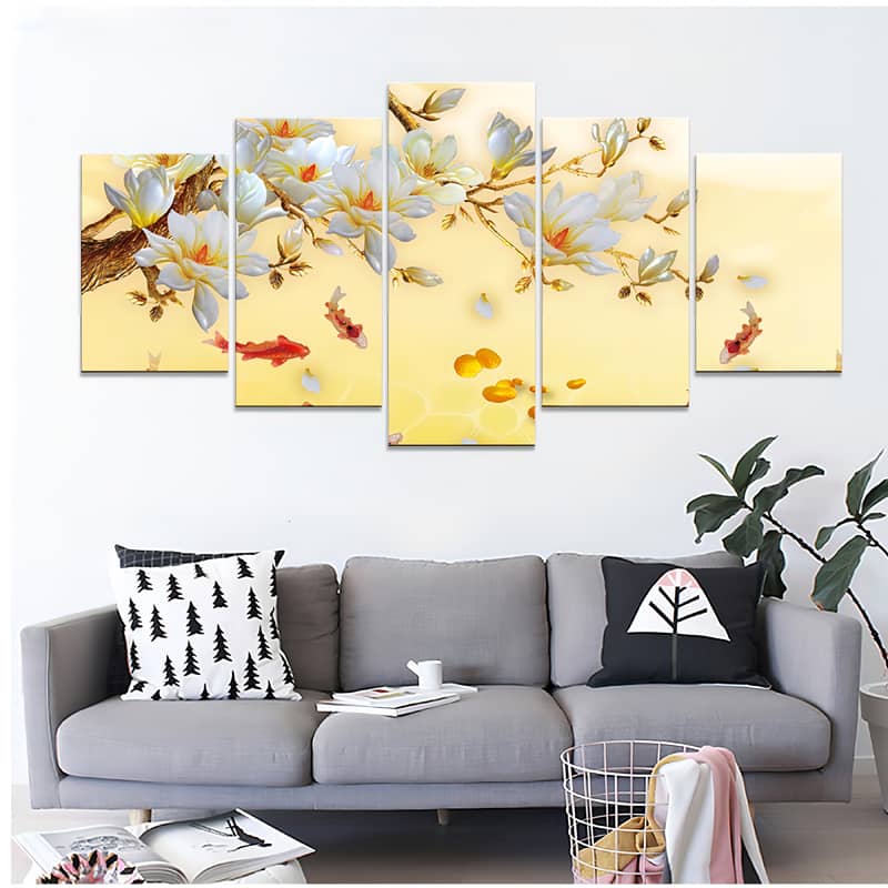 Diamond painting set of 5 pieces featuring a serene yellow koi pond with flowers, displayed above a modern grey sofa.