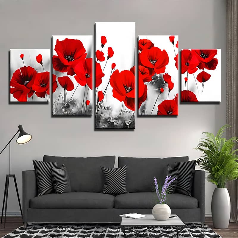 Five-part diamond painting of vibrant red poppies against a black and white background, displayed above a modern living room sofa.