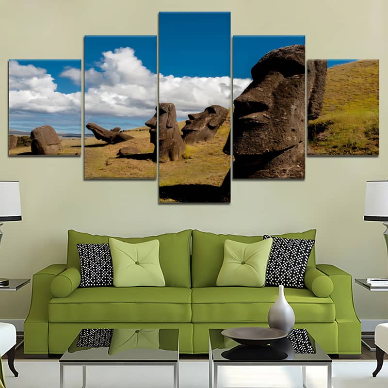 Diamond painting featuring five pieces of Easter Island rock faces above a green sofa in a modern living room setting.