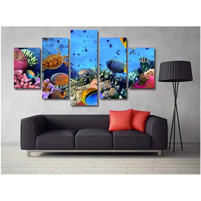 Diamond Painting 5-piece set of underwater turtle and fish with coral, displayed on a gray wall above a black sofa with red cushions.