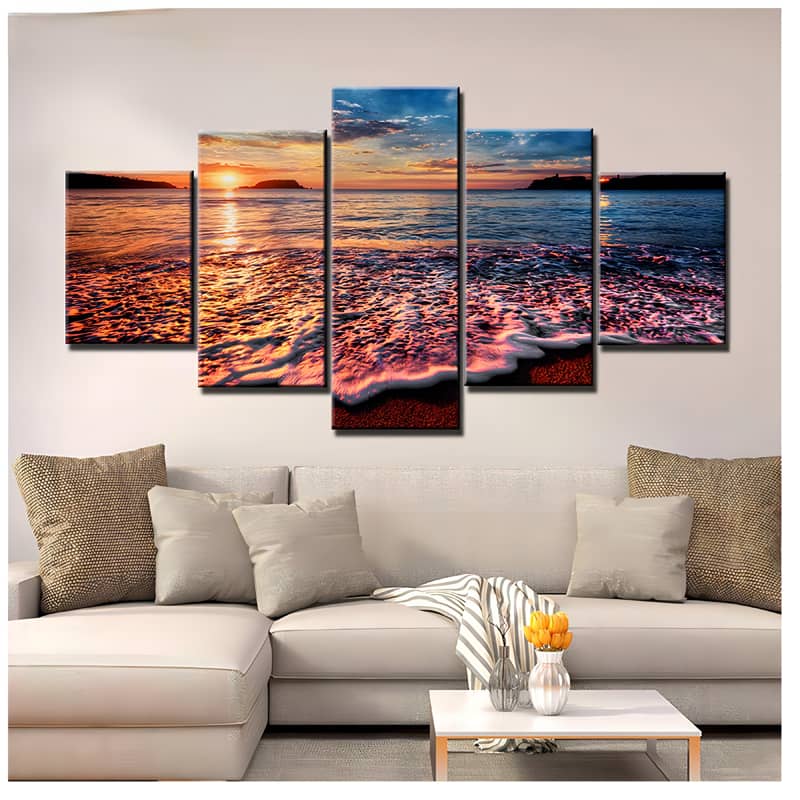 Diamond Painting 5 pieces set depicting sunset over the sea with gentle waves, displayed above a modern sofa in a cozy living room.