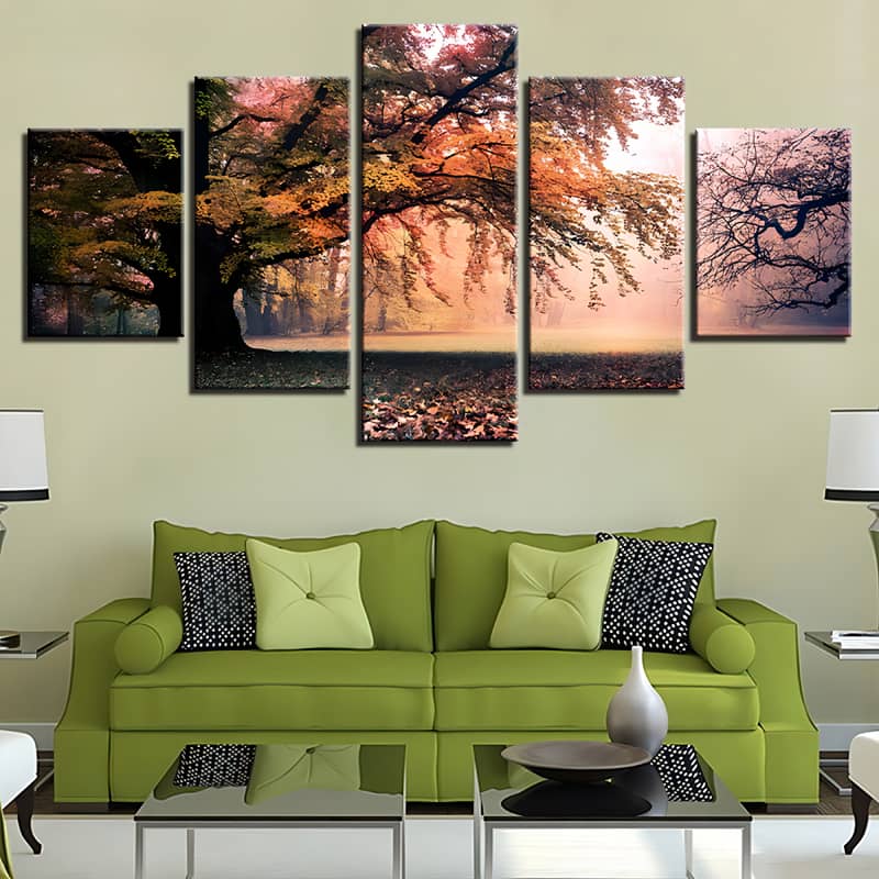 Diamond painting set of 5 pieces depicting a serene forest meadow with big and old trees, hanging above a green sofa.