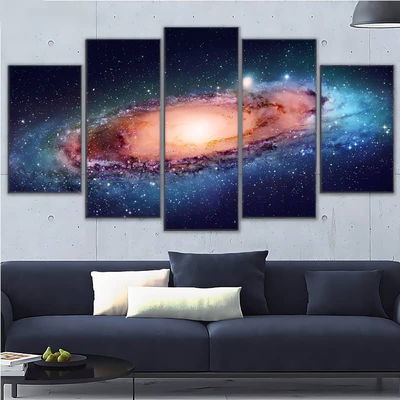Diamond Painting 5 pieces featuring a shining galaxy in space displayed above a modern couch in a stylish living room.